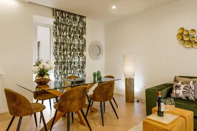 a living room with a glass table and chairs at Eden Luxury Apartment in Rome