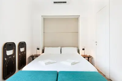 a bedroom with a white bed with blue sheets at Luxury Apartment - Vatican Area - Key Collection in Rome