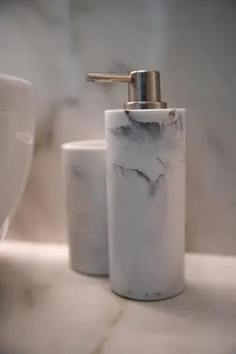 a soap dispenser sitting on top of a sink at Luxury Apartment - Vatican Area - Key Collection in Rome