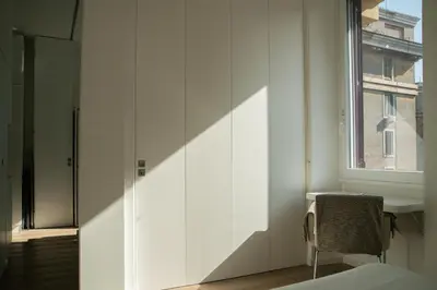 a bedroom with a window and a white wall at Luxury Apartment - Vatican Area - Key Collection in Rome