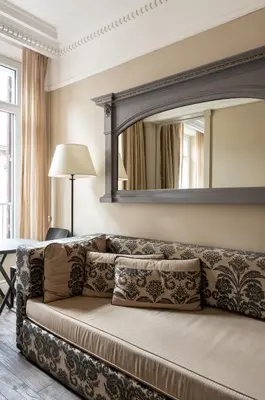 a couch in a living room with a mirror at Casa Montani in Rome