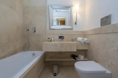 a bathroom with a tub and a toilet and a sink at Casa Montani in Rome