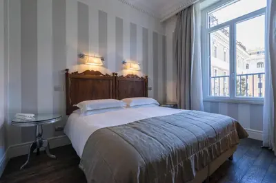 a bedroom with a large bed and a window at Casa Montani in Rome