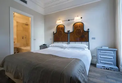 a bedroom with a large bed with a wooden headboard at Casa Montani in Rome