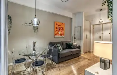 a living room with a glass table and a couch at FRAM Vatican Apartment in Rome