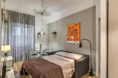 a bedroom with a bed and a table at FRAM Vatican Apartment in Rome
