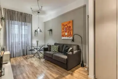 a living room with a couch and a table at FRAM Vatican Apartment in Rome