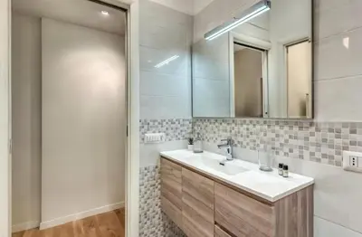 a bathroom with a sink and a mirror at FRAM Vatican Apartment in Rome