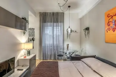a bedroom with a large bed and a table at FRAM Vatican Apartment in Rome
