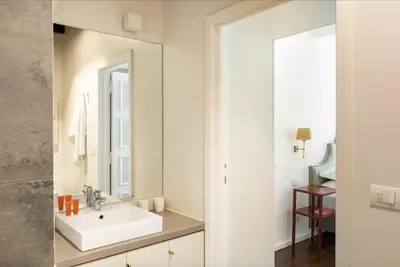 a bathroom with a sink and a mirror at Residenza Torre Vecchiarelli - apt 4 in Rome