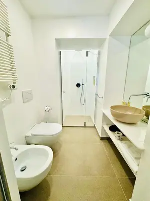 a bathroom with a toilet and a sink and a shower at Residenza Torre Vecchiarelli - apt 4 in Rome