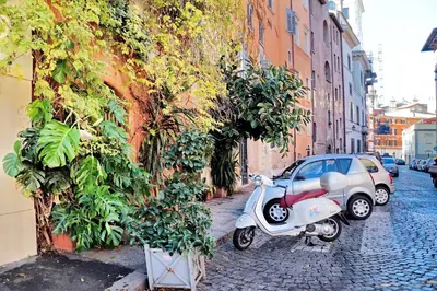 a scooter parked on a street next to a building at Residenza Torre Vecchiarelli - apt 4 in Rome