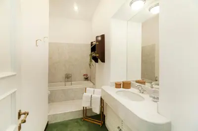 a white bathroom with a sink and a tub at Roma Colosseo, vista da sogno in Rome