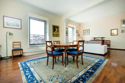 a living room with a table and chairs and a couch at Roma Colosseo, vista da sogno in Rome