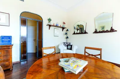 a dining room with a wooden table and chairs at Roma Colosseo, vista da sogno in Rome