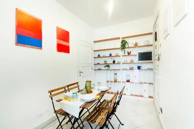 a dining room with a white table and chairs at Roma Colosseo, vista da sogno in Rome
