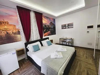 a bedroom with a bed with towels on it at Susys's Guest House - Room Castel Sant'Angelo in Rome