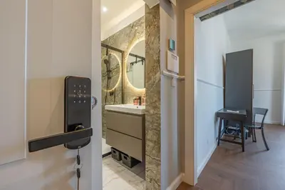 a bathroom with a sink and a mirror and a table at Residenza Degli Speziali Roma Prati in Rome