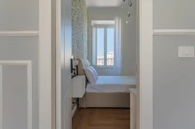 a small bedroom with a bed and a window at Residenza Degli Speziali Roma Prati in Rome