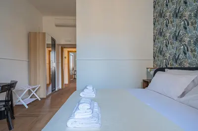 a bedroom with a white bed with towels on it at Residenza Degli Speziali Roma Prati in Rome