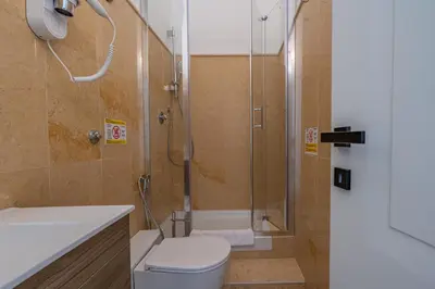 a bathroom with a shower and a toilet and a sink at Residenza Degli Speziali Roma Prati in Rome