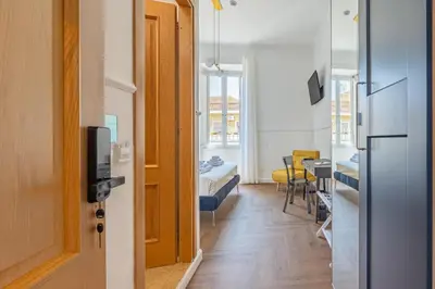 a room with a hallway with a room with a table at Residenza Degli Speziali Roma Prati in Rome