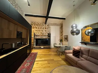 a kitchen and living room with a couch and a table at Luxury Loft near Via Veneto in Rome