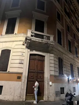a man standing in front of a building with a large door at Luxury Loft near Via Veneto in Rome