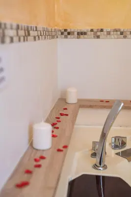 a kitchen counter with a sink and candles on it at Roma Design Rooms San Giovanni Colosseo Area in Rome