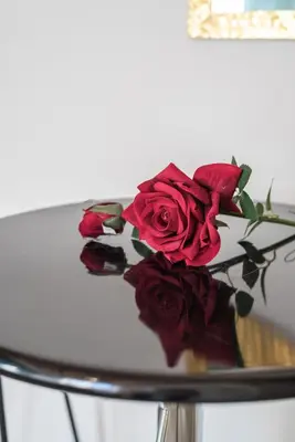 a bouquet of red roses sitting on a table at Roma Design Rooms San Giovanni Colosseo Area in Rome