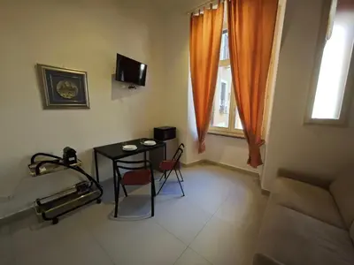 a small living room with a table and a couch at Appartamento Alida in Rome