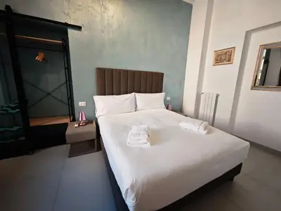 a bedroom with a large bed with two towels on it at Appartamento Alida in Rome