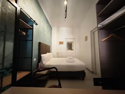 a small bedroom with a bed in a room at Appartamento Alida in Rome