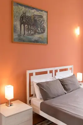 a bedroom with a bed and a painting on the wall at Vista Laterana in Rome