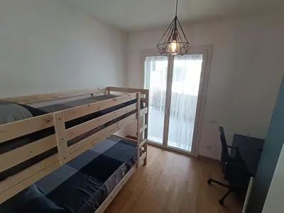 a bedroom with a bunk bed and a large window at Pato's Home - Appartamento Condiviso Con Parcheggio Gratuito in Rome