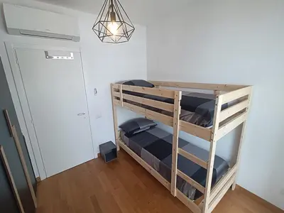 a bunk bed in a room with a light at Pato's Home - Appartamento Condiviso Con Parcheggio Gratuito in Rome