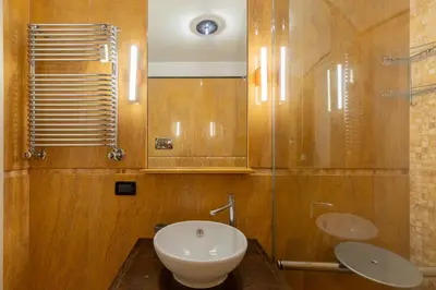 a bathroom with a sink and a toilet and a mirror at Celeste Retreat al Pantheon - Homkeey Apartments in Rome