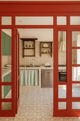 a kitchen with red sliding doors in a kitchen at Aurelio APT - Homkeey Apartments in Rome
