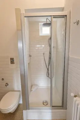 a bathroom with a shower and a toilet at Aurelio APT - Homkeey Apartments in Rome
