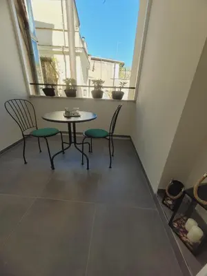 a table and chairs in a room with a window at imperium suite trevi in Rome