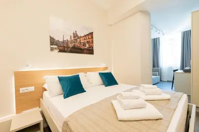 a bedroom with a large bed with towels on it at imperium suite trevi in Rome