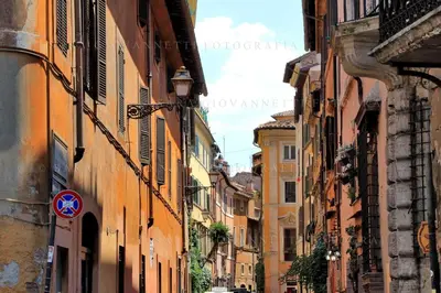 an alley in an old town with buildings at Rosa Trastevere Magic Location in Rome