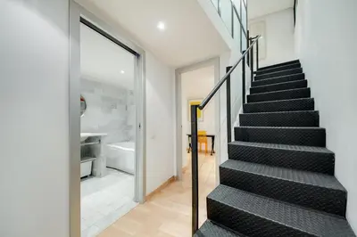 a staircase in a house with a glass wall at Rosa Trastevere Magic Location in Rome
