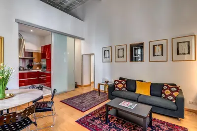 a living room with a couch and a table at Rosa Trastevere Magic Location in Rome