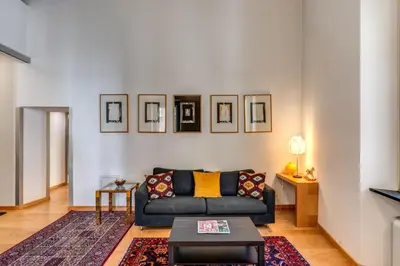 a living room with a couch and a table at Rosa Trastevere Magic Location in Rome