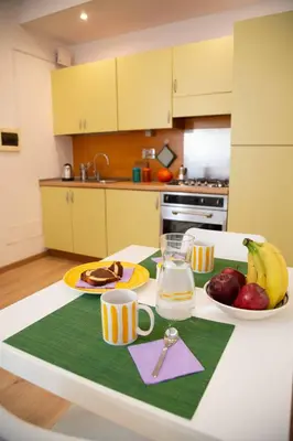 a kitchen with a table with food and fruit on it at La casetta nascosta in Rome