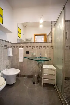a bathroom with a sink and a glass counter at La casetta nascosta in Rome