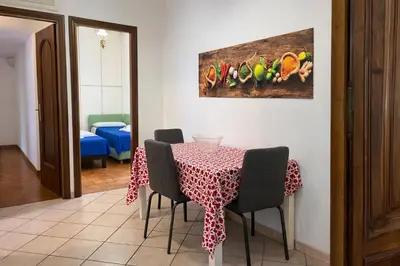 a dining room with a table with chairs and a painting at -Colosseum 15 Min -Trastevere, Free Wi-Fi and A-C in Rome