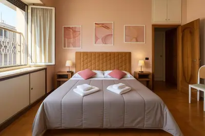 a bedroom with a large bed with two towels on it at -Colosseum 15 Min -Trastevere, Free Wi-Fi and A-C in Rome