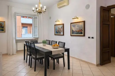 a dining room with a black table and chairs at -Colosseum 15 Min -Trastevere, Free Wi-Fi and A-C in Rome